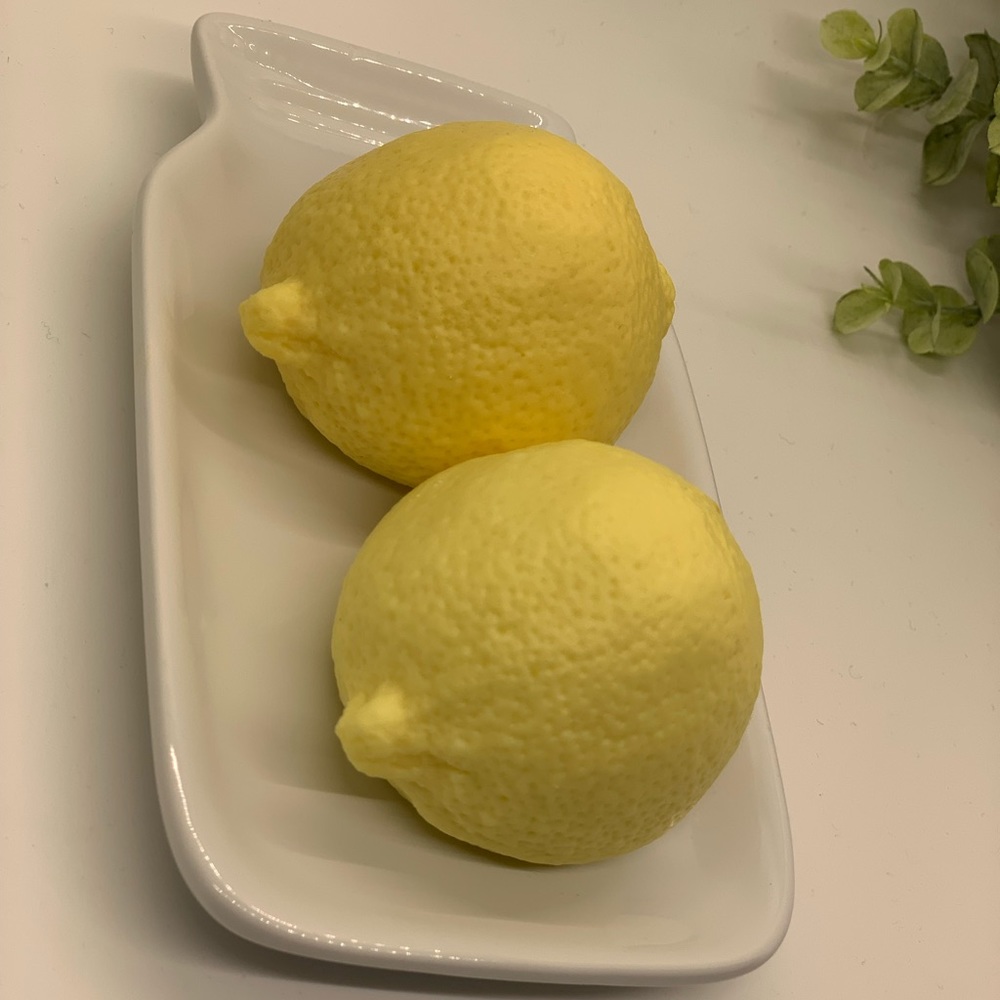 2 lemon soaps on ceramic dish